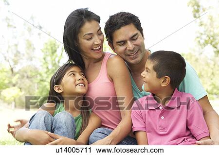 Stock Image - Portrait Of Young Family In Park. Fotosearch