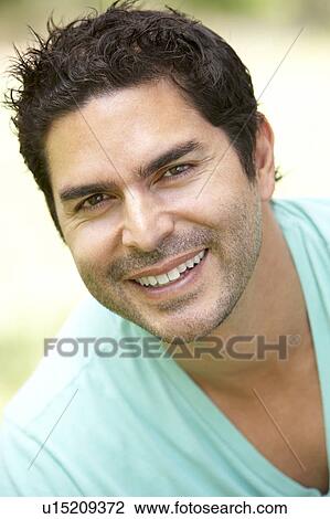 Stock Image - Portrait Of Young Man In Park. Fotosearch