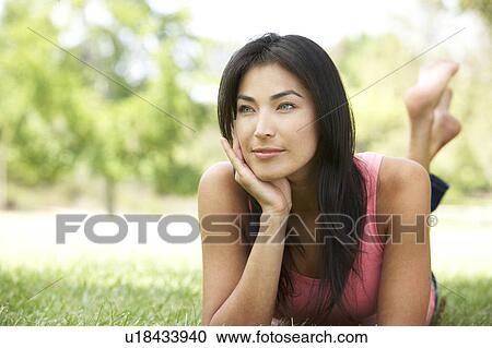 Stock Image - Portrait Of Young Woman In Park. Fotosearch