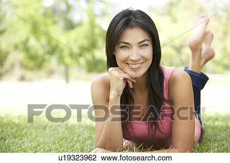 Stock Image - Portrait Of Young Woman In Park. Fotosearch