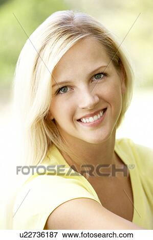 Portrait Of Young Woman Sitting In Park View Large Photo Image Stock Photo - Portrait Of Young Woman Sitting In Park. Fotosearch