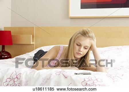 Sad Teenage Girl In Bedroom With Mobile Phone View Large Photo Image Stock Photography - Sad Teenage Girl In Bedroom With Mobile Phone. Fotosearch