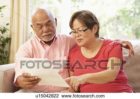 Senior Couple Discussing Document At Home View Large Photo Image Stock Image - Senior Couple Discussing Document At Home. Fotosearch