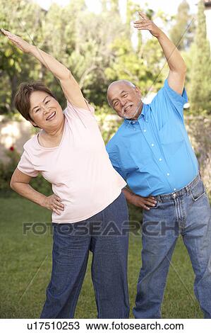 Senior Couple Exercising In Garden View Large Photo Image Stock Image - Senior Couple Exercising In Garden. Fotosearch