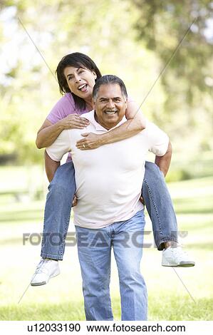 Stock Image - Senior Couple Having Fun In Park. Fotosearch