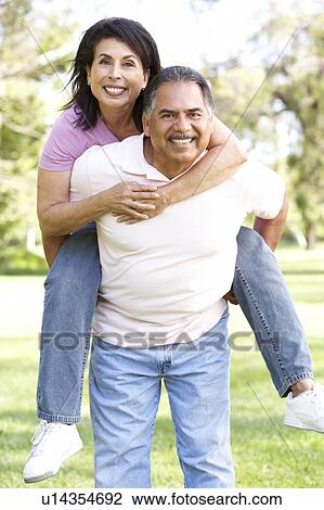 Stock Image - Senior Couple Having Fun In Park. Fotosearch