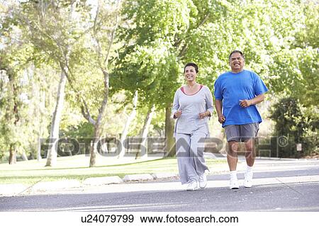 Stock Photo - Senior Couple Jogging In Park. Fotosearch
