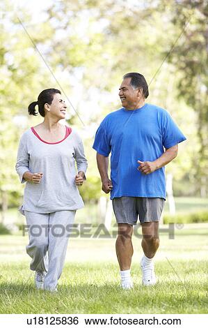 Stock Photograph - Senior Couple Jogging In Park. Fotosearch