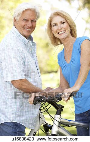 Senior Couple On Cycle Ride In Park View Large Photo Image Stock Image - Senior Couple On Cycle Ride In Park. Fotosearch
