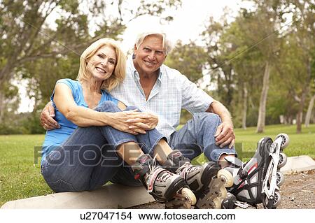 Senior Couple Putting On In Line Skates In Park View Large Photo Image Picture - Senior Couple Putting On In Line Skates In Park. Fotosearch