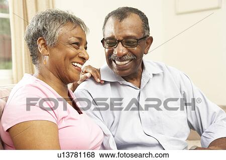 Stock Photo - Senior Couple Relaxing At Home Together. Fotosearch