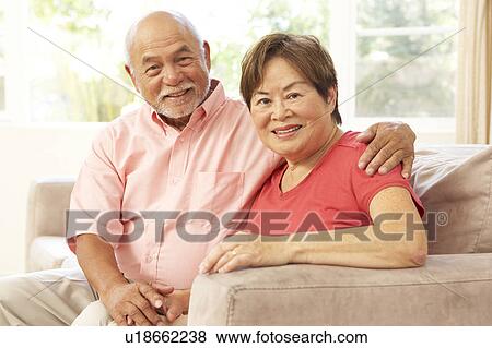 Stock Photo - Senior Couple Relaxing At Home Together. Fotosearch