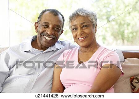 Stock Photograph - Senior Couple Relaxing At Home Together. Fotosearch