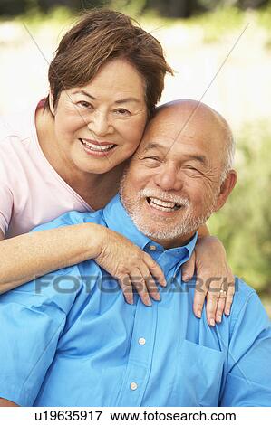 Senior Couple Relaxing In Garden Together View Large Photo Image Stock Photo - Senior Couple Relaxing In Garden Together. Fotosearch