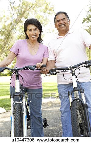 Senior Couple Riding Bikes In Park View Large Photo Image Stock Photograph - Senior Couple Riding Bikes In Park. Fotosearch