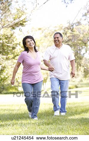 Picture - Senior Couple Running In Park. Fotosearch