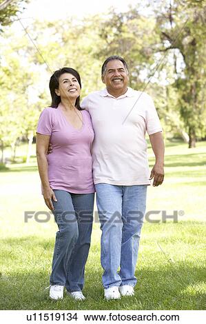 Picture - Senior Couple Walking In Park. Fotosearch