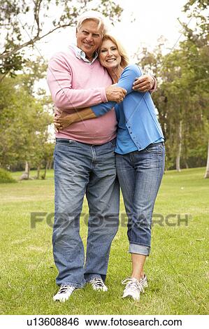 Stock Photograph - Senior Couple Walking In Park. Fotosearch