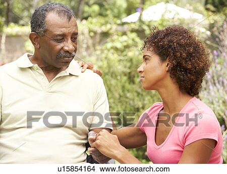 Senior Man Being Consoled By Adult Daughter View Large Photo Image Picture - Senior Man Being Consoled By Adult Daughter. Fotosearch