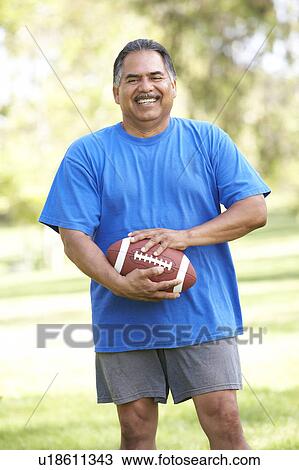 Senior Man Exercising With American Football In Park View Large Photo Image Stock Image - Senior Man Exercising With American Football In Park. Fotosearch