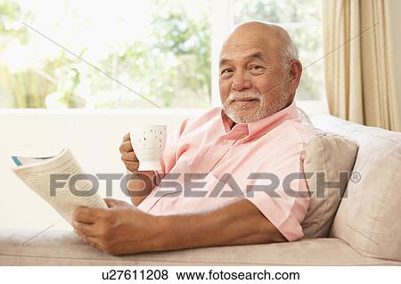 Senior Man Reading Book With Drink At Home View Large Photo Image Stock Photo - Senior Man Reading Book With Drink At Home. Fotosearch