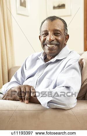 Stock Photo - Senior Man Relaxing In Chair At Home. Fotosearch