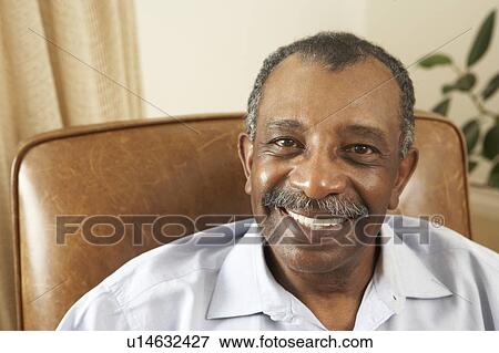 Stock Photo - Senior Man Relaxing In Chair At Home. Fotosearch