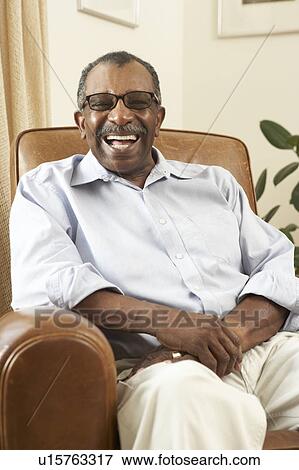 Stock Photo - Senior Man Relaxing In Chair At Home. Fotosearch