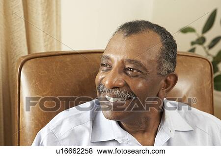 Stock Photo - Senior Man Relaxing In Chair At Home. Fotosearch