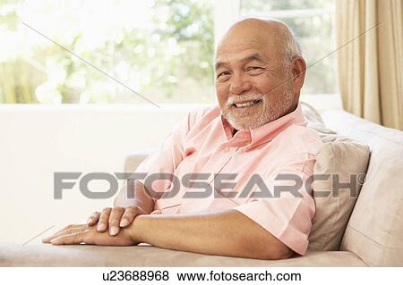Stock Photo - Senior Man Relaxing In Chair At Home. Fotosearch