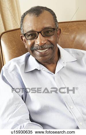Senior Man Relaxing In Chair At Home View Large Photo Image Stock Photography - Senior Man Relaxing In Chair At Home. Fotosearch