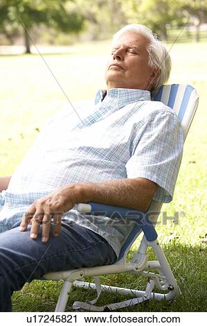 Stock Image - Senior Man Relaxing In Park. Fotosearch