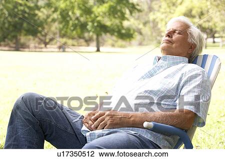 Stock Image - Senior Man Relaxing In Park. Fotosearch