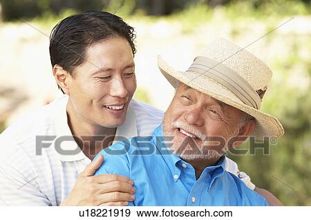 Senior Man With Adult Son In Garden View Large Photo Image Stock Photo - Senior Man With Adult Son In Garden. Fotosearch