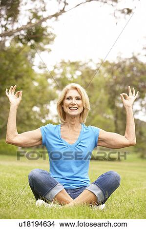Picture - Senior Woman Doing Yoga In Park. Fotosearch