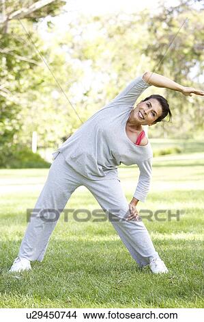Picture - Senior Woman Exercising In Park. Fotosearch
