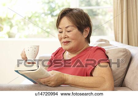 Senior Woman Reading Book With Drink At Home View Large Photo Image Picture - Senior Woman Reading Book With Drink At Home. Fotosearch