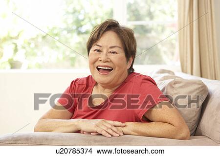Senior Woman Relaxing In Chair At Home View Large Photo Image Picture - Senior Woman Relaxing In Chair At Home. Fotosearch