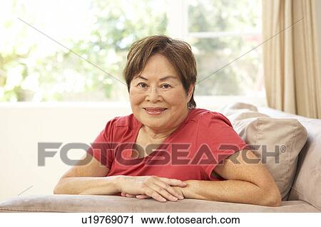 Senior Woman Relaxing In Chair At Home View Large Photo Image Stock Image - Senior Woman Relaxing In Chair At Home. Fotosearch