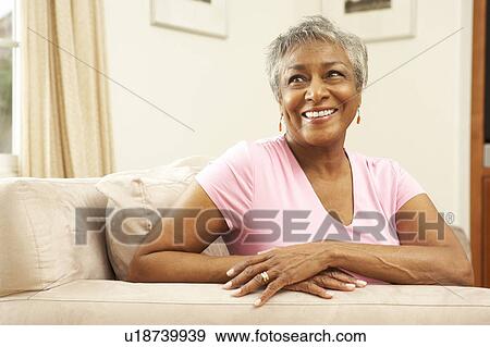 Stock Photo - Senior Woman Relaxing In Chair At Home. Fotosearch
