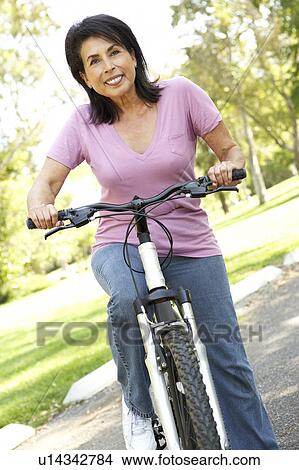 Senior Woman Riding Bike In Park View Large Photo Image Picture - Senior Woman Riding Bike In Park. Fotosearch