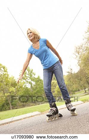 Stock Image - Senior Woman Skating In Park. Fotosearch