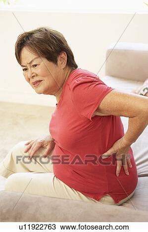 Senior Woman Suffering From Back Pain At Home View Large Photo Image Stock Image - Senior Woman Suffering From Back Pain At Home. Fotosearch