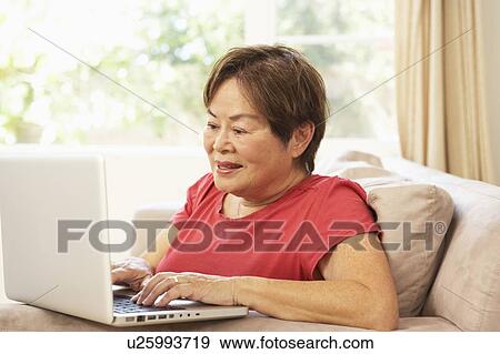 Stock Photo - Senior Woman Using Laptop At Home. Fotosearch