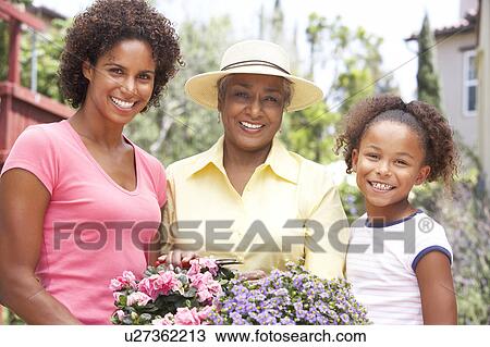 Senior Woman With Adult Daughter And Granddaughter Gardening Together View Large Photo Image Stock Image - Senior Woman With Adult Daughter And Granddaughter Gardening Together. Fotosearch