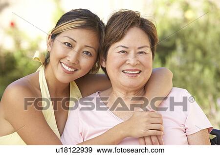 Senior Woman With Adult Daughter In Garden Together View Large Photo Image Stock Photo - Senior Woman With Adult Daughter In Garden Together. Fotosearch