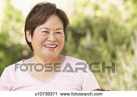 Smiling Senior Woman In Garden View Large Photo Image Stock Image - Smiling Senior Woman In Garden. Fotosearch