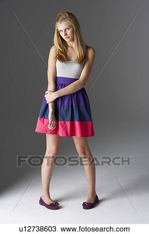 Stock Image - Studio Portrait Of Fashionably Dressed Teenage Girl. Fotosearch