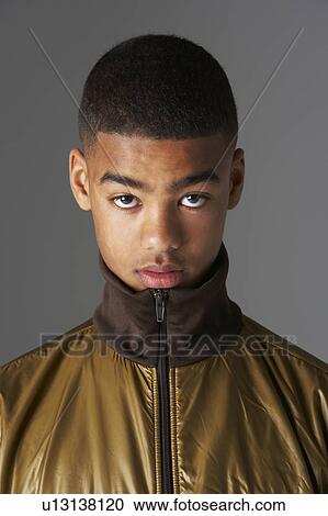 Stock Image - Studio Portrait Of Fashionably Dressed Teenage Boy. Fotosearch
