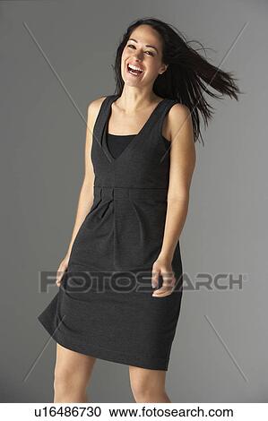 Stock Image - Studio Portrait Of Fashionably Dressed Woman. Fotosearch